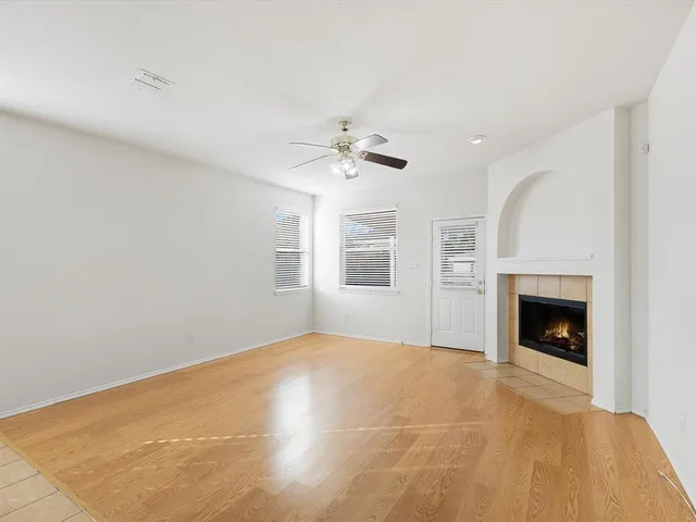 a view of a livingroom with a fireplace and a ceiling fan