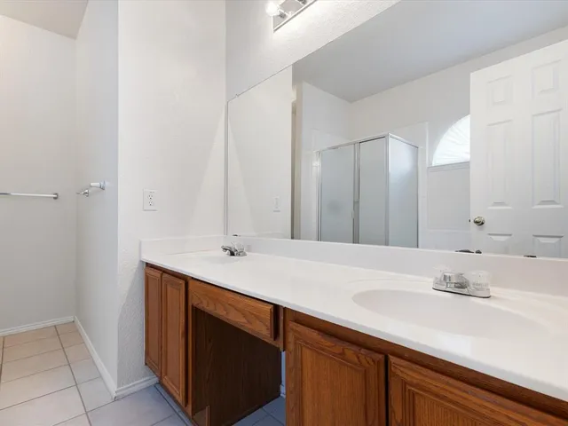 a spacious bathroom with a bathtub sink and mirror