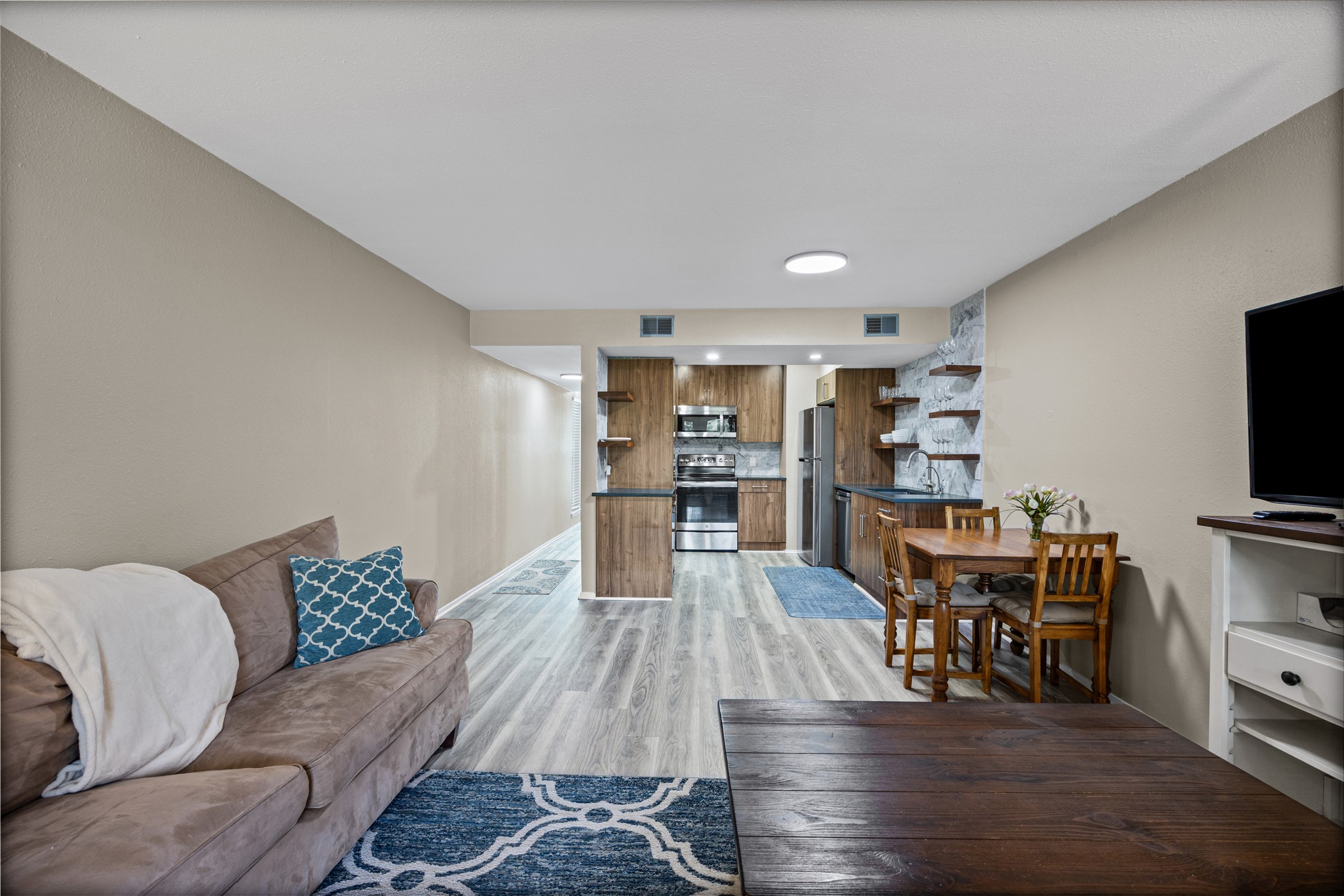 3809 Menchaca Road, Unit C Austin, TX 78704 - Photo 2 of 28 A cohesive living space showcasing an open-concept kitchen and welcoming dining area.