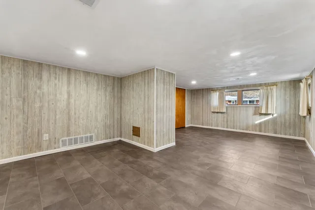 an empty room with a empty space and windows