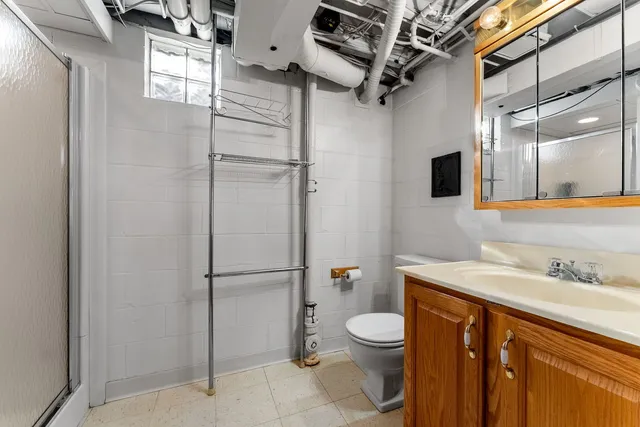 a bathroom with a granite countertop sink toilet and shower
