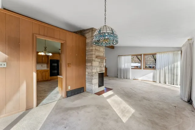 a view of a big room with windows and chandelier