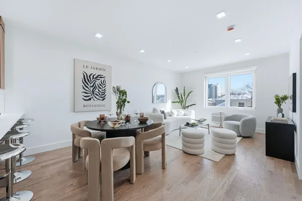 a living room with furniture potted plant and a window