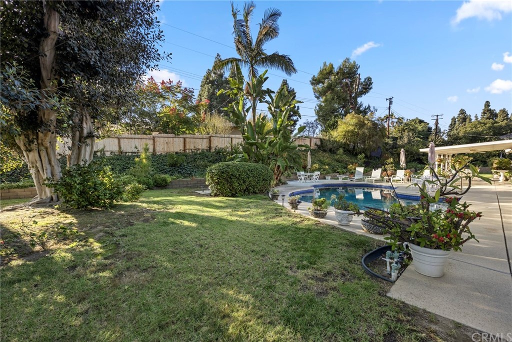 610 Laguna Road Fullerton, CA 92835 - Photo 27 of 29 a backyard of a house with table and chairs plants and large trees