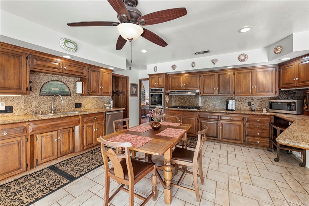 610 Laguna Road Fullerton, CA 92835 - Photo 7 of 29 a kitchen with stainless steel appliances kitchen island granite countertop a sink and cabinets