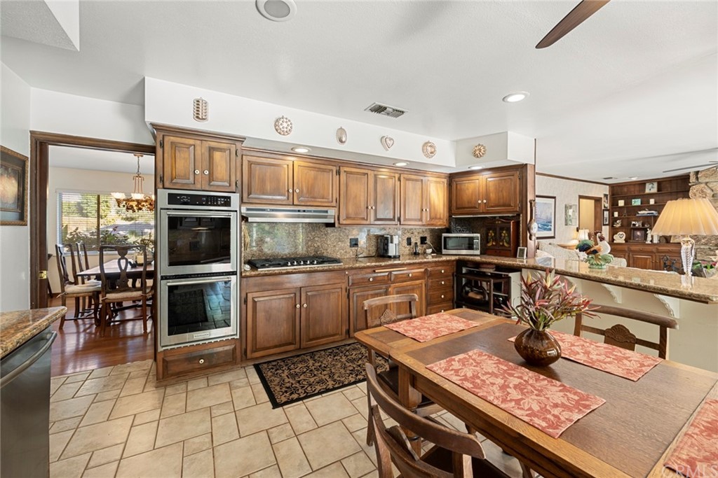 610 Laguna Road Fullerton, CA 92835 - Photo 8 of 29 a kitchen with stainless steel appliances a stove a sink a microwave and cabinets