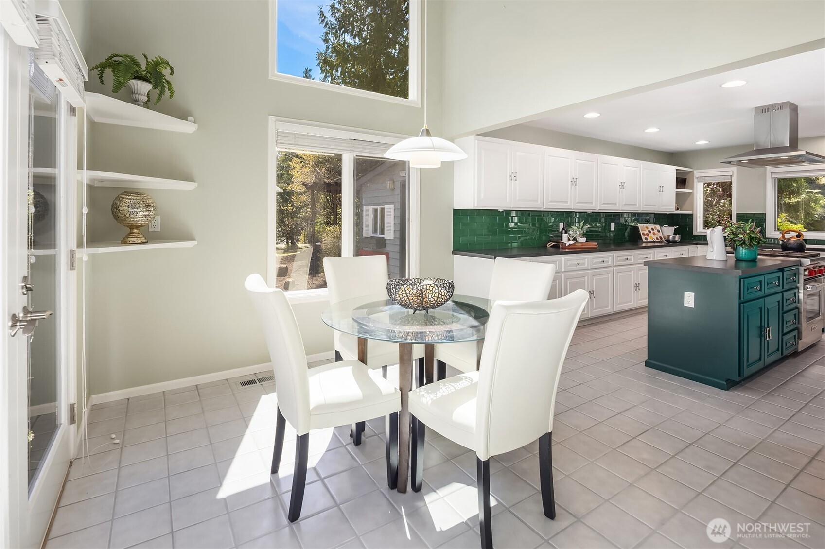 16309 110th Avenue Northeast Bothell, WA 98011 - Photo 14 of 38 a kitchen with stainless steel appliances kitchen island granite countertop a table and chairs in it