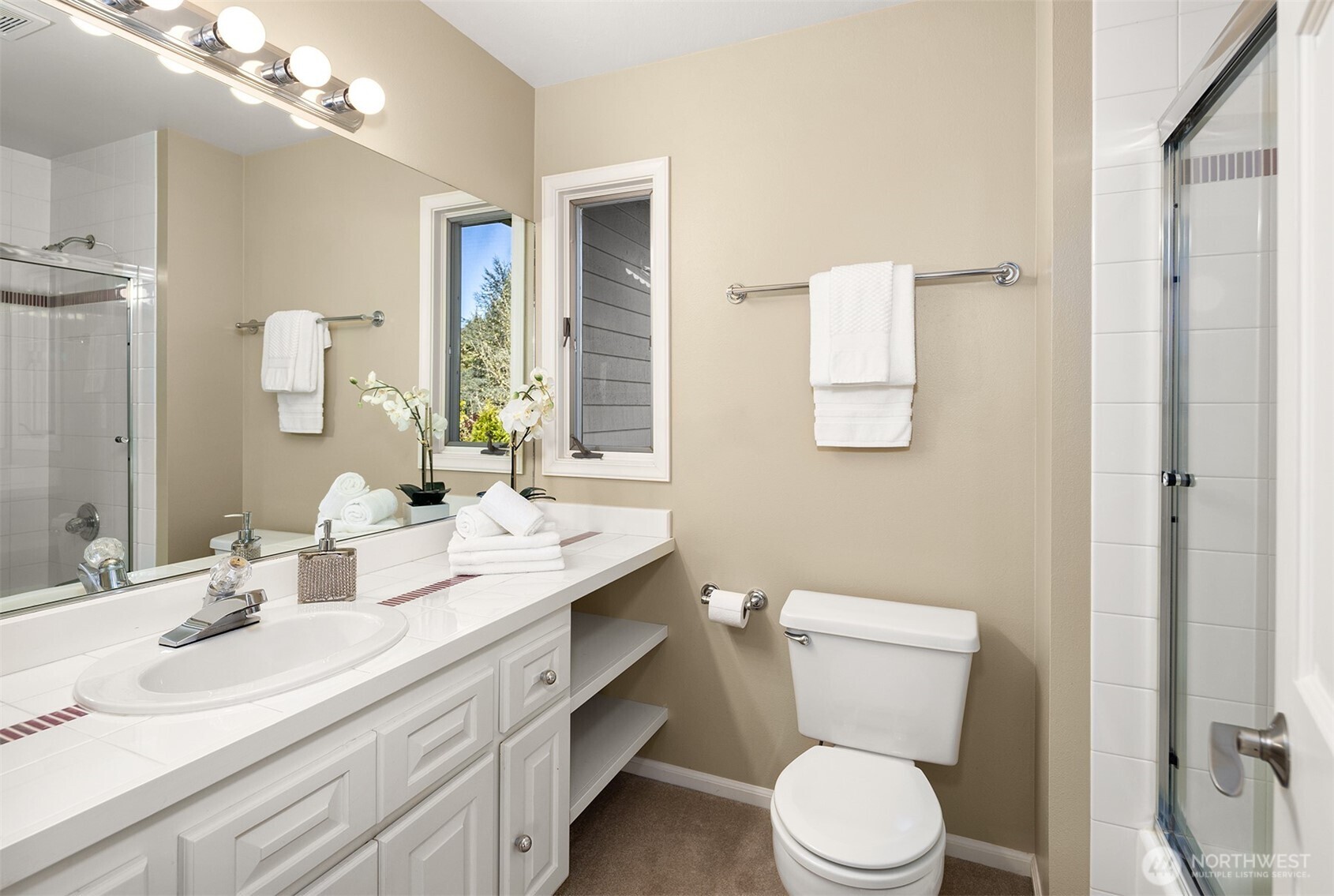16309 110th Avenue Northeast Bothell, WA 98011 - Photo 27 of 38 a bathroom with a toilet a sink a mirror a vanity and window