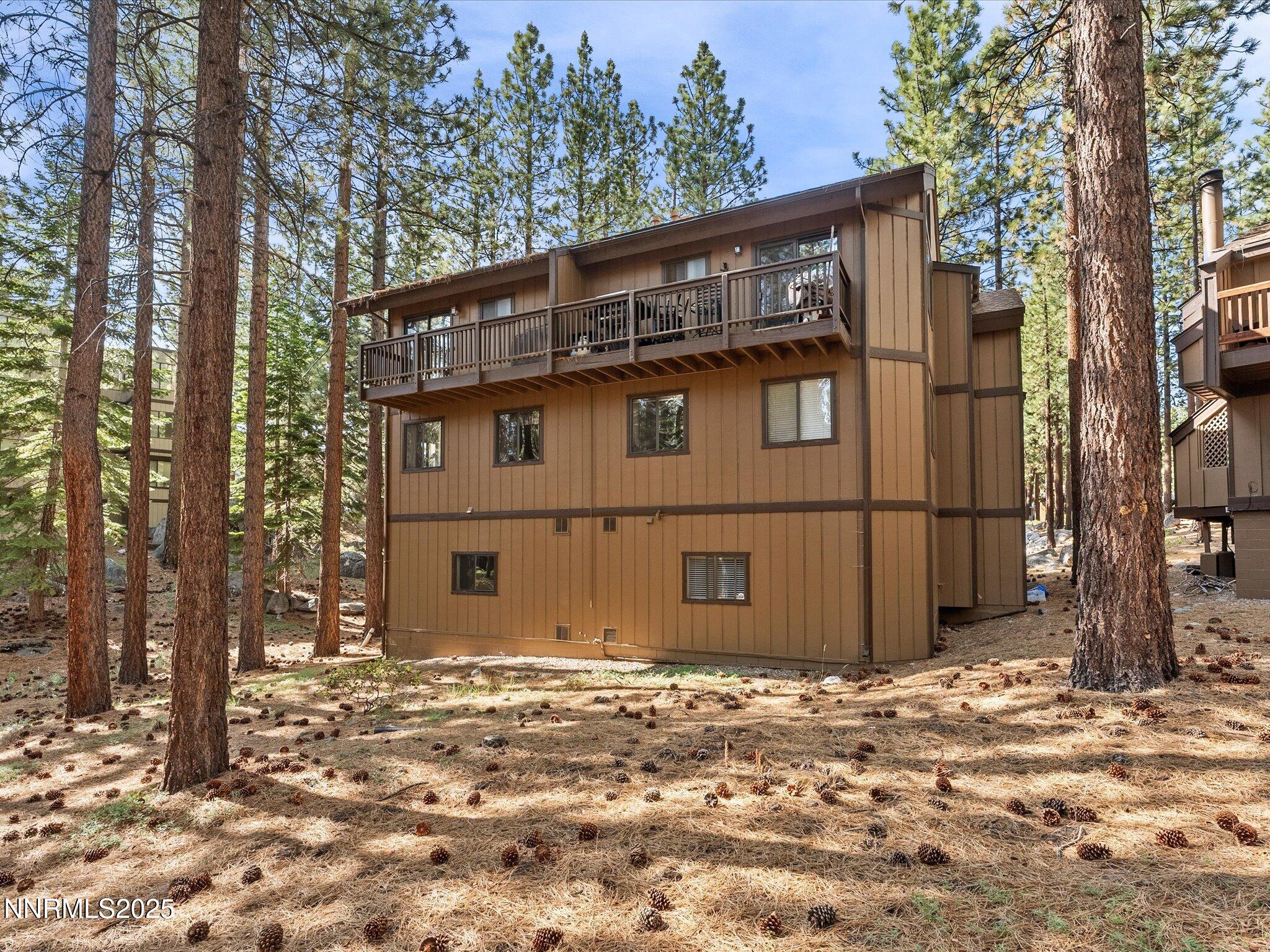178 Tahoma Circle, Unit B Stateline, NV 89449 - Photo 33 of 52 a view of a house with a large tree and wooden fence
