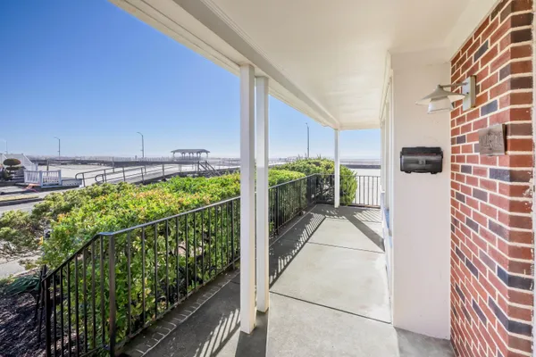 a view of roof deck with two chairs and wooden floor