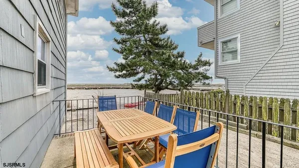 a kitchen with stainless steel appliances granite countertop a refrigerator a stove and a sink