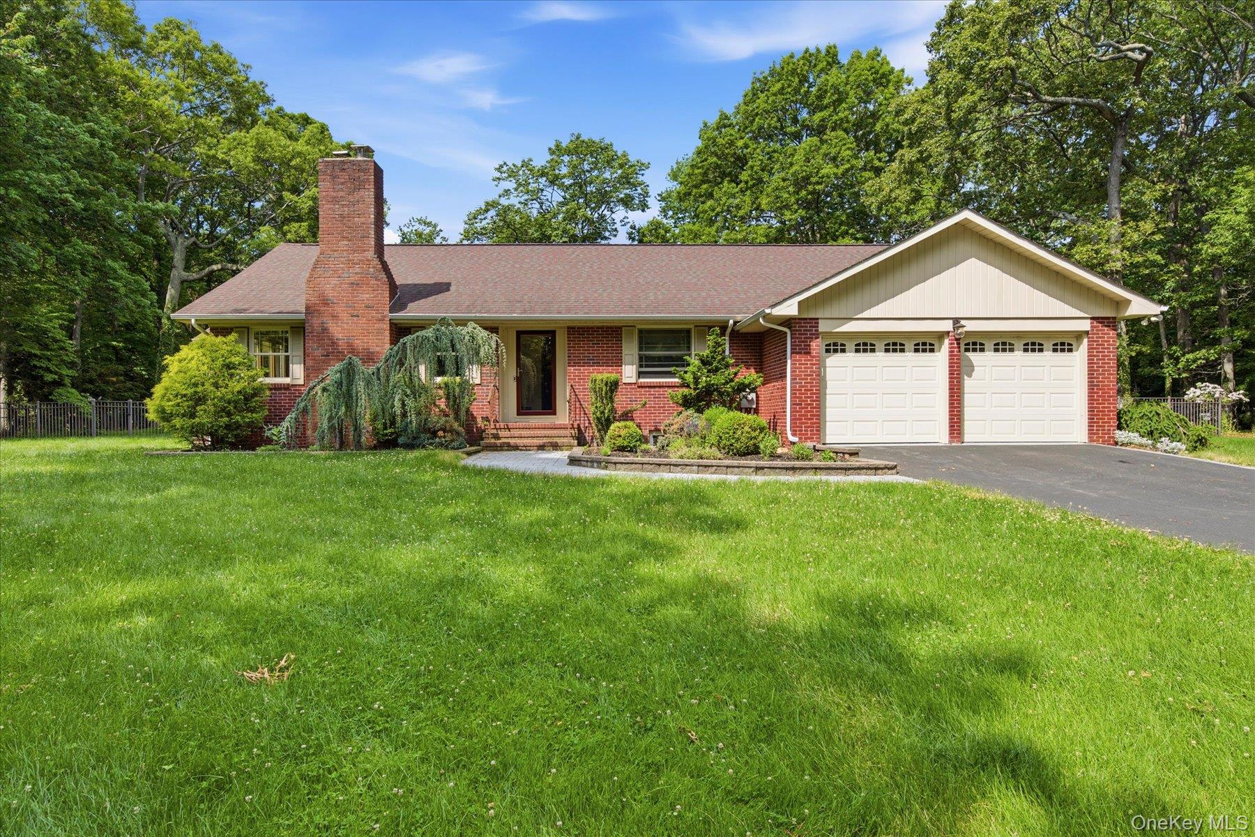 42 Cliff Road Port Jefferson, NY 11777 - Photo 1 of 22 a front view of a house with a yard and garage