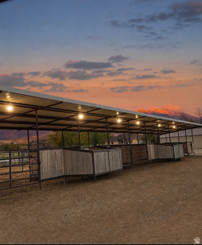 115 East 1600th Street North Santaquin, UT 84655 - Photo 50 of 52 Covered horse stalls with integrated lighting, metal roof, and wood-paneled partitions