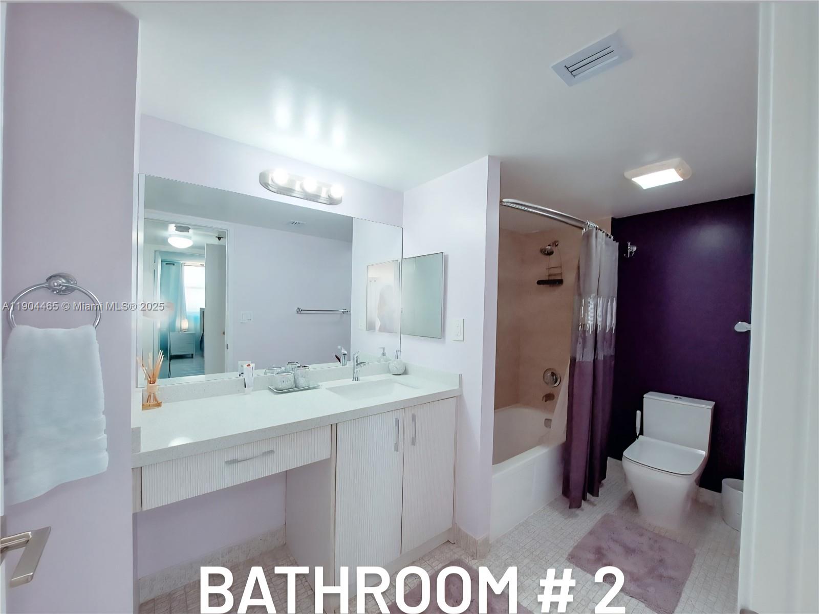 Sunny Isles Beach Sunny Isles Beach, FL 33160 - Photo 11 of 11 a bathroom with a sink a toilet and a large mirror