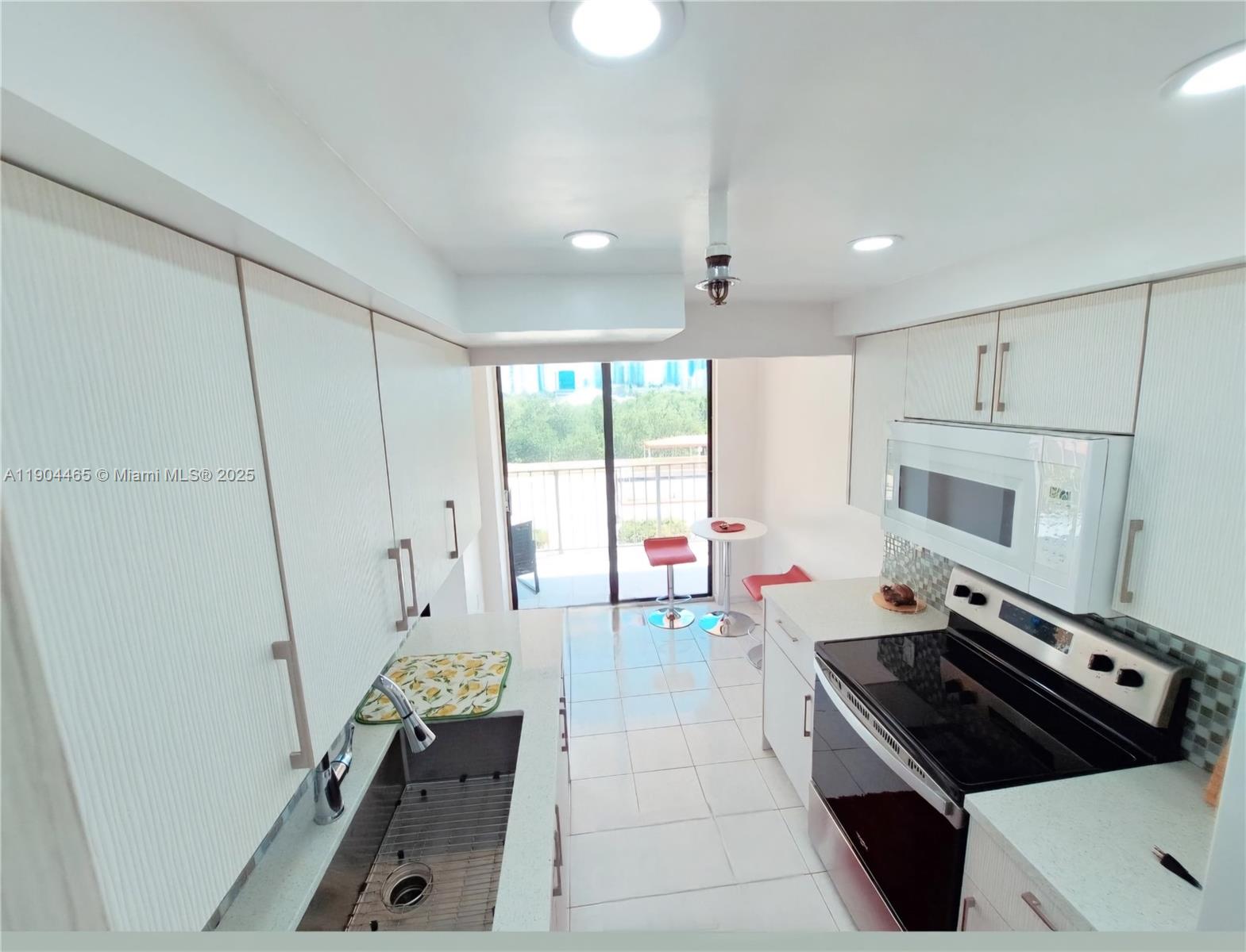 Sunny Isles Beach Sunny Isles Beach, FL 33160 - Photo 4 of 11 a kitchen with a stove and a refrigerator