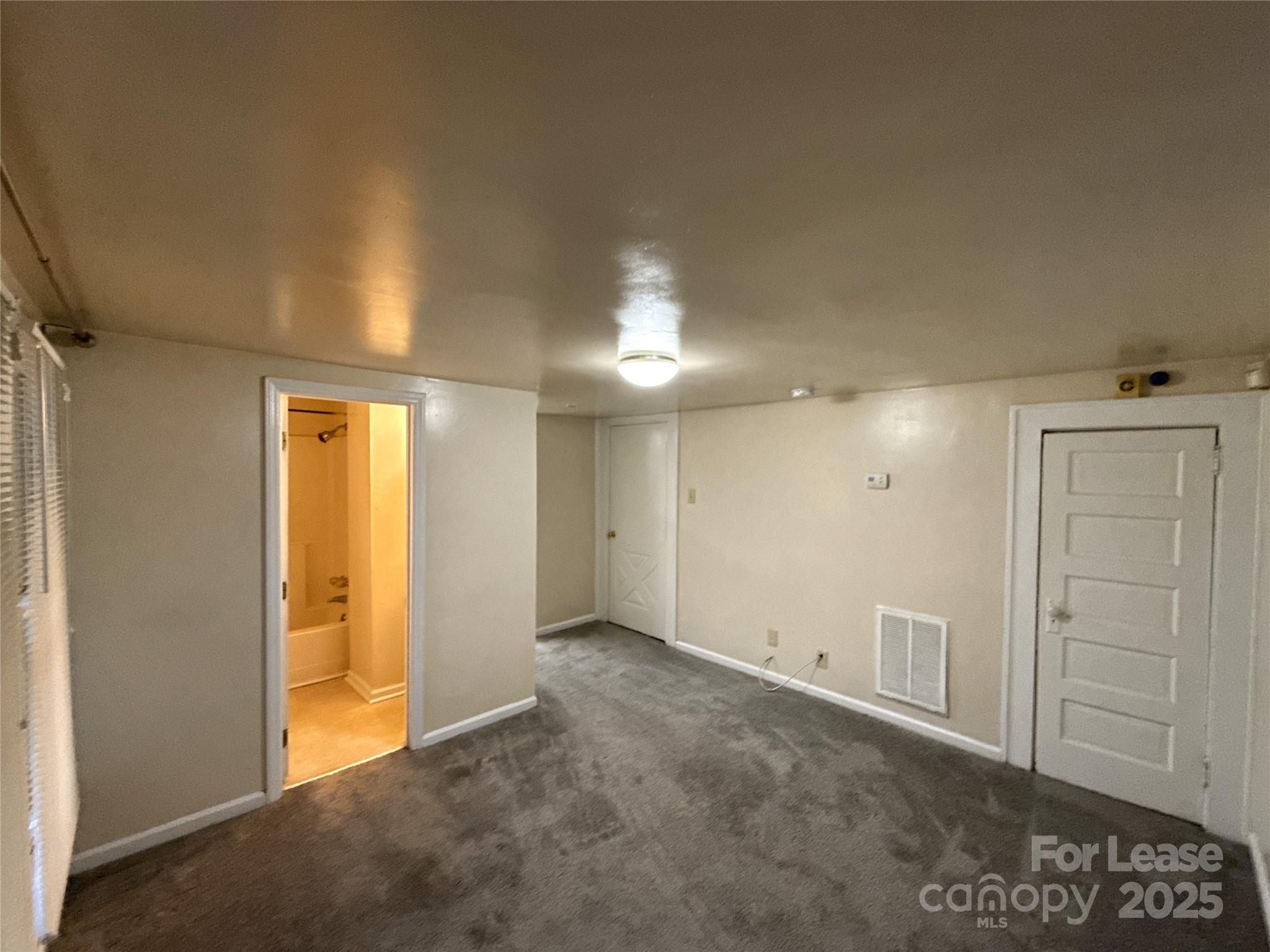 1433 Pecan Avenue, Unit C Charlotte, NC 28205 - Photo 3 of 10 an empty room with closet area