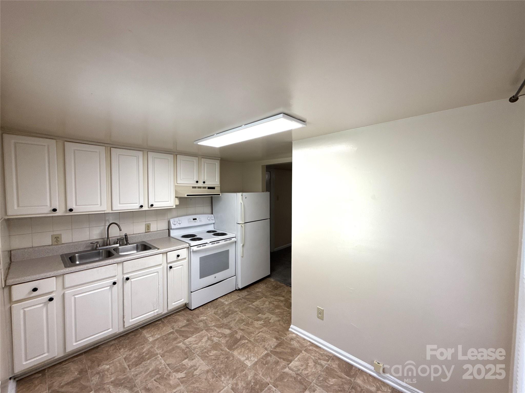 1433 Pecan Avenue, Unit C Charlotte, NC 28205 - Photo 4 of 10 a kitchen with a sink cabinets and stainless steel appliances
