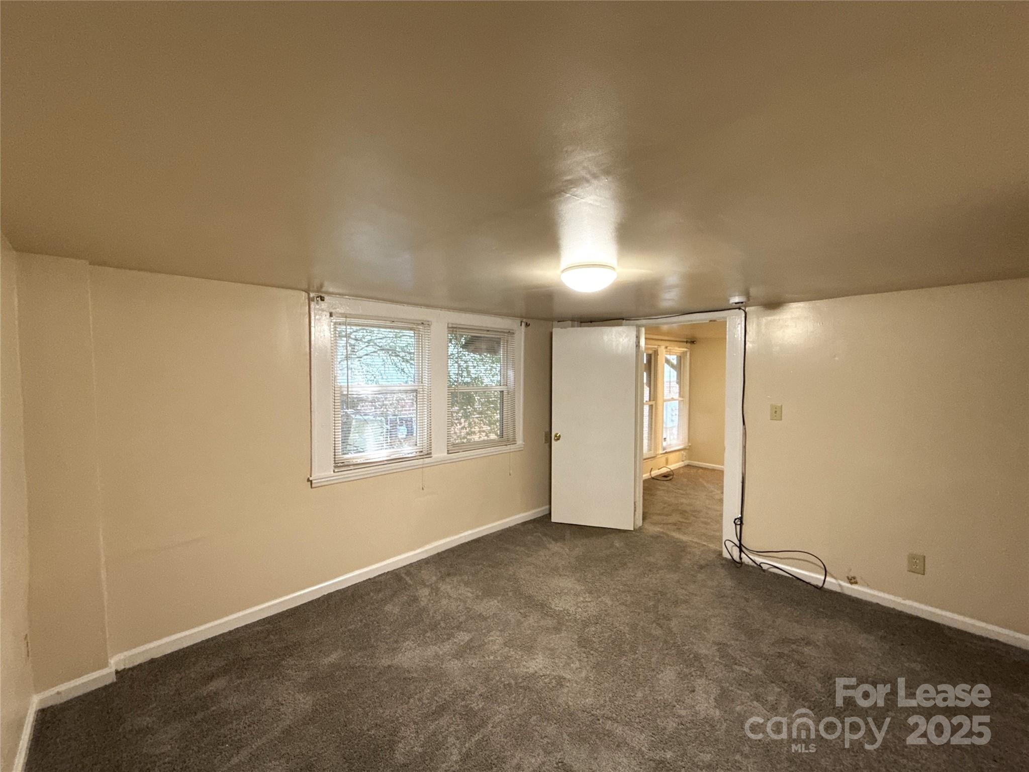 1433 Pecan Avenue, Unit C Charlotte, NC 28205 - Photo 6 of 10 an empty room with windows and closet