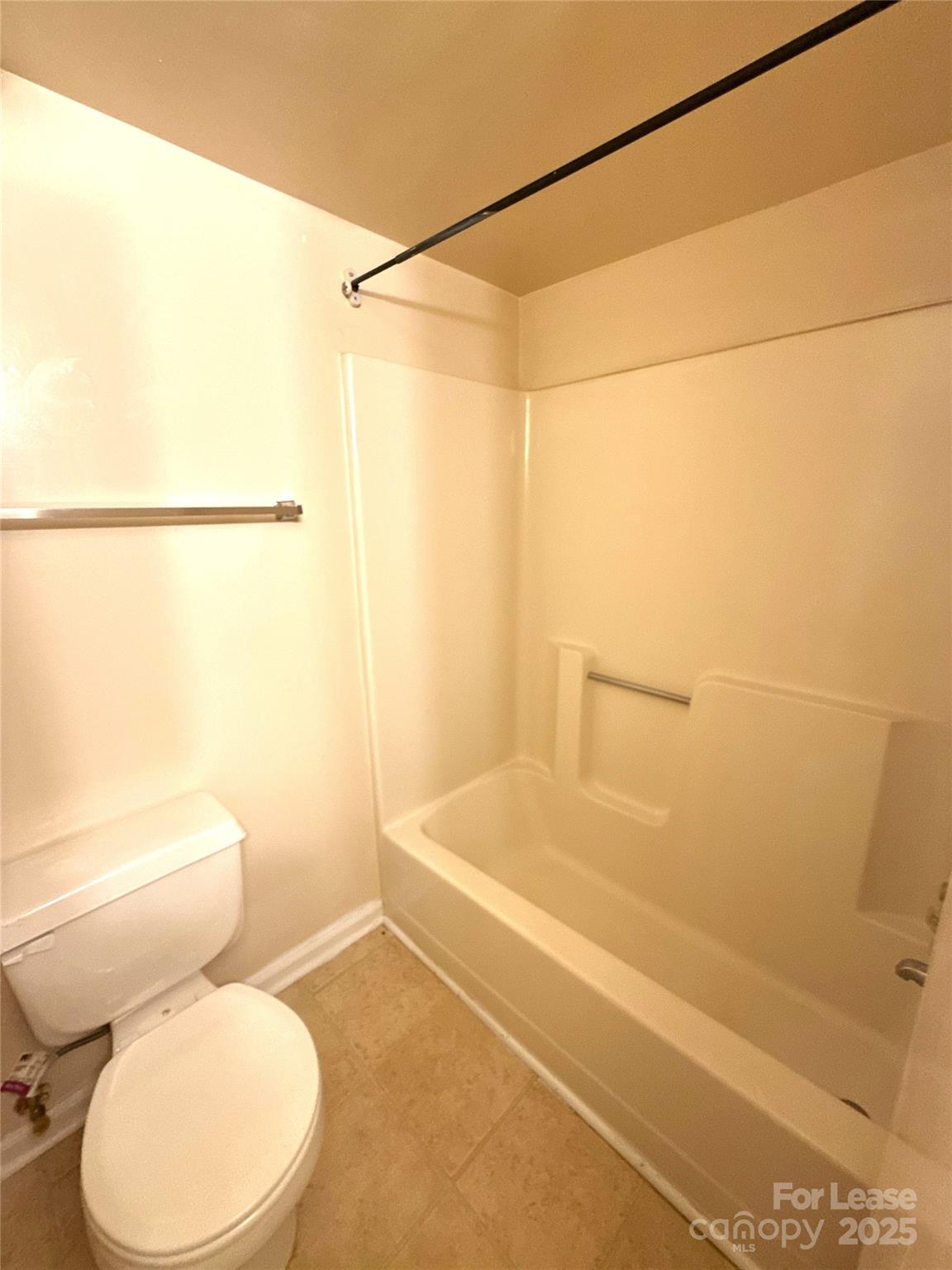 1433 Pecan Avenue, Unit C Charlotte, NC 28205 - Photo 8 of 10 a white toilet sitting next to a bath tub and a shower