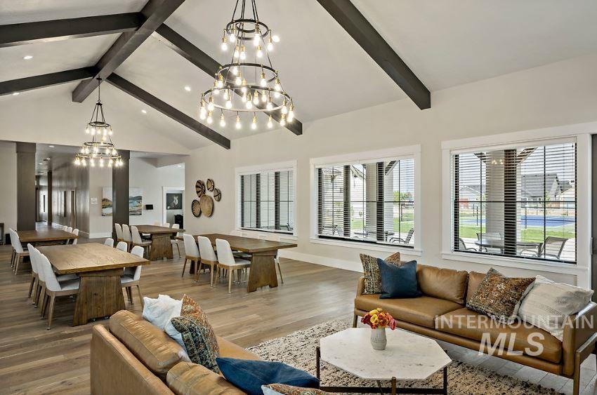 3480 East Macumbo Lane Meridian, ID 83642 - Photo 36 of 43 Living room with beam ceiling, wood finished floors, a chandelier, and high vaulted ceiling