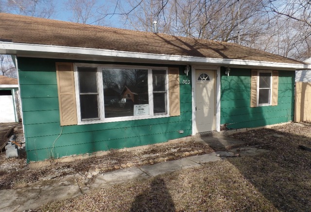 303 Louis Road Joliet, IL 60433 - Photo 1 of 14 a view of a brick house with a large windows
