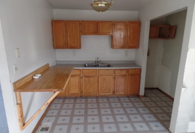 303 Louis Road Joliet, IL 60433 - Photo 3 of 14 a kitchen with a sink and cabinets