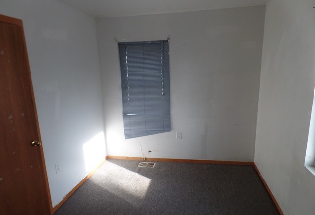 303 Louis Road Joliet, IL 60433 - Photo 5 of 14 an empty room with a wooden door