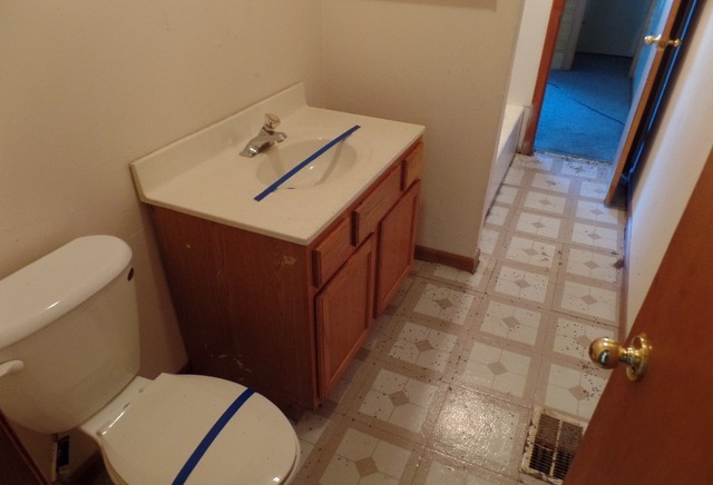 303 Louis Road Joliet, IL 60433 - Photo 7 of 14 a bathroom with a toilet a sink and a mirror