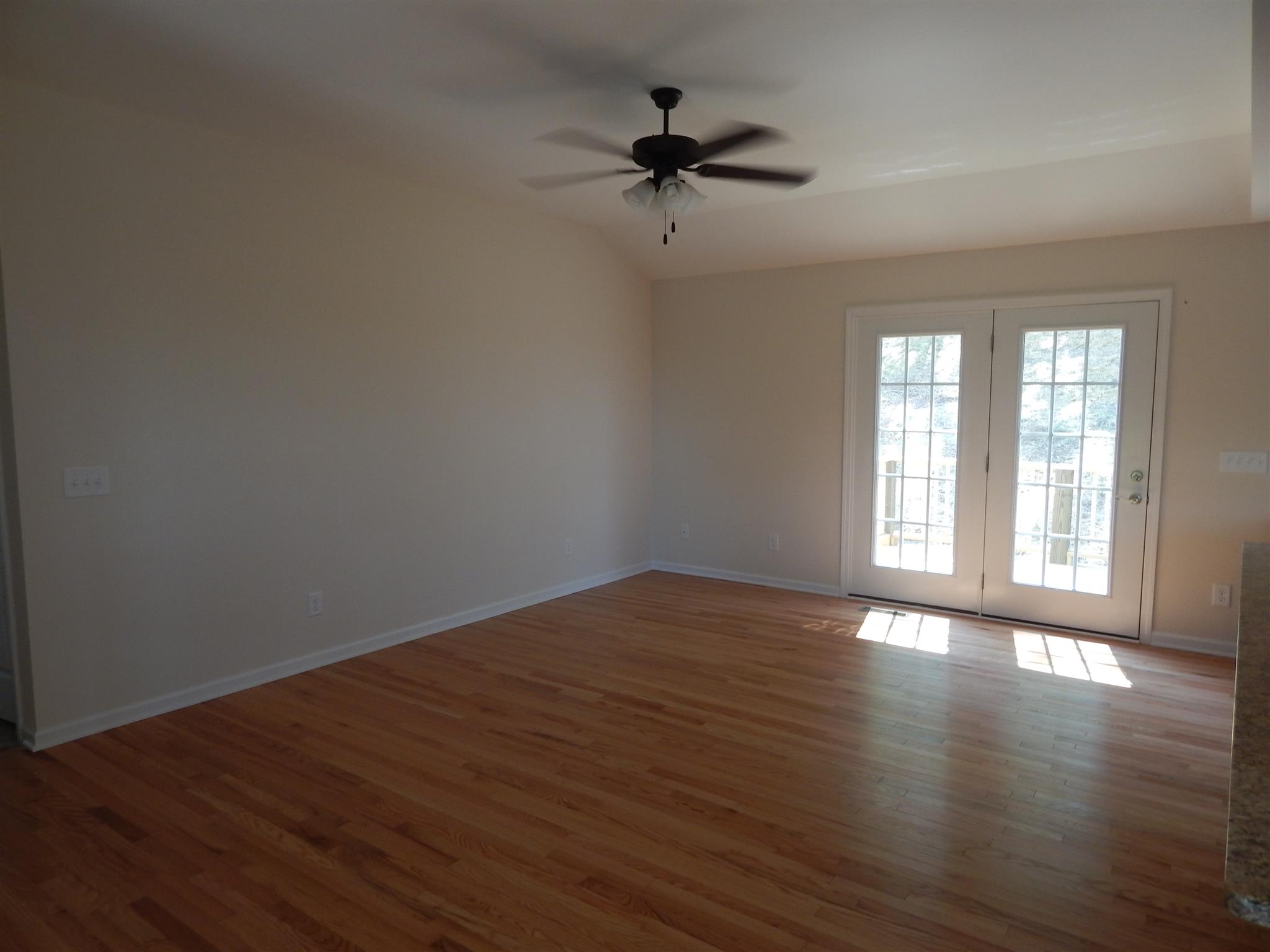 1545 Heller Ridge Spring Hill, TN 37174 - Photo 3 of 19 a view of an empty room with a window and wooden floor