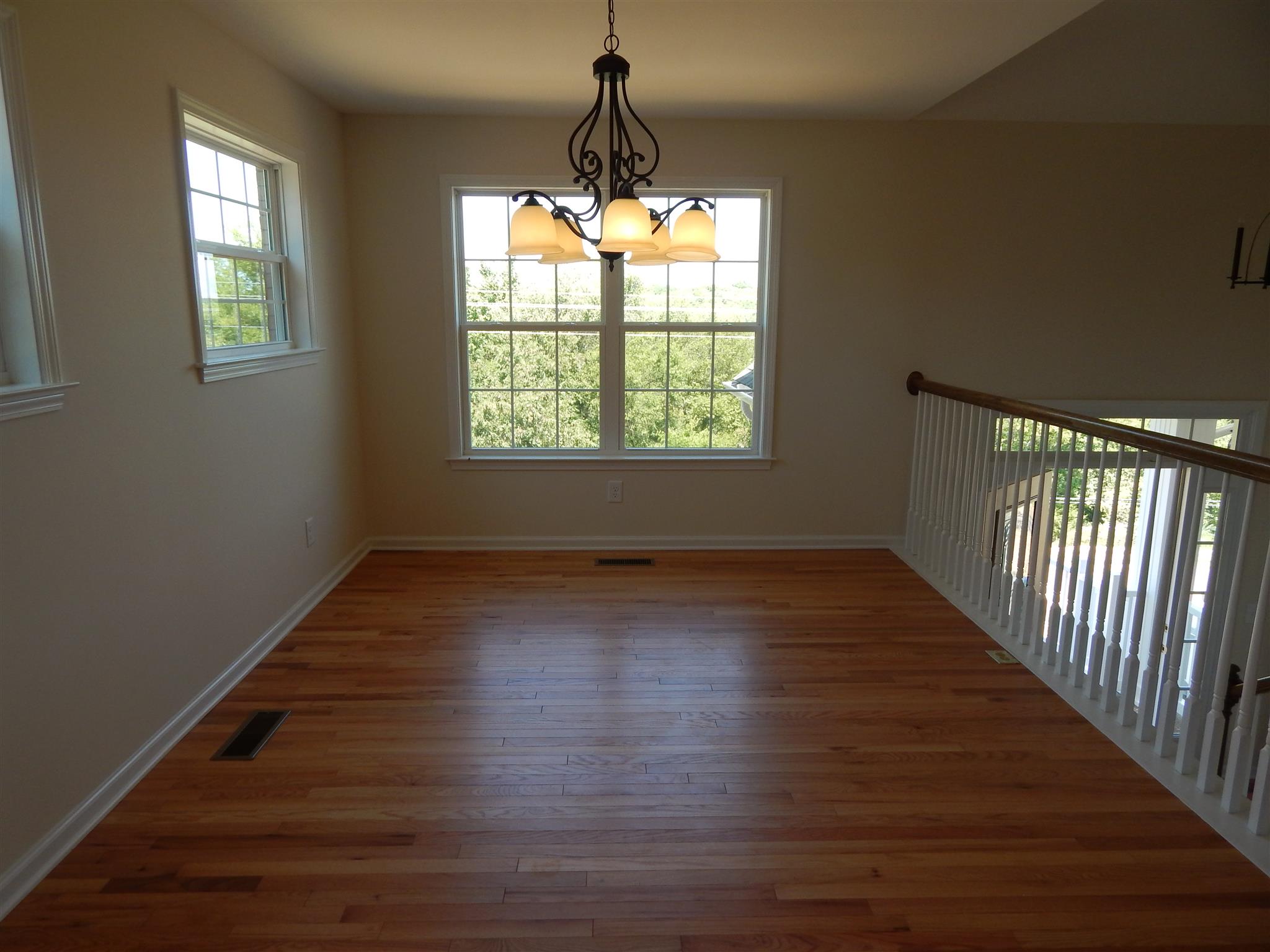 1545 Heller Ridge Spring Hill, TN 37174 - Photo 4 of 19 an empty room with wooden floor and windows