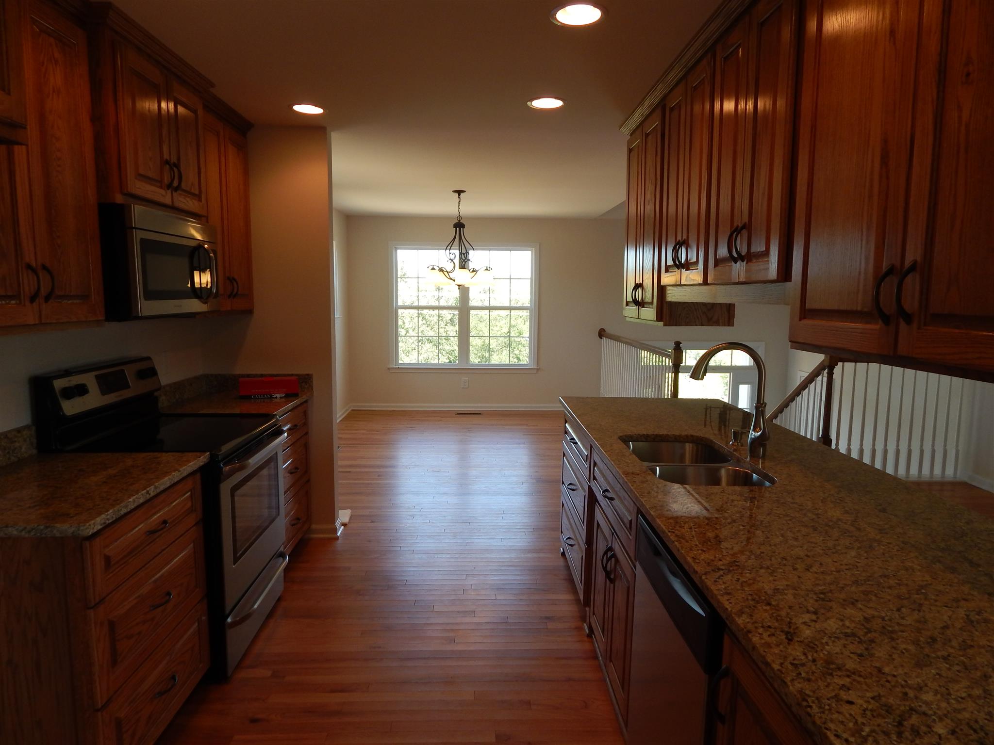 1545 Heller Ridge Spring Hill, TN 37174 - Photo 6 of 19 a kitchen that has a sink a stove and wooden floor
