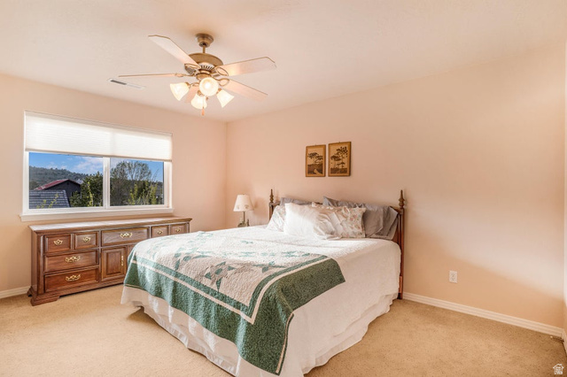 48 South Sage Road Pine Valley, UT 84781 - Photo 39 of 61 Bedroom featuring a ceiling fan with integrated lighting, a large window, and carpet flooring
