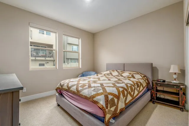 a bed room with a bed and a chair