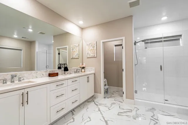 a bathroom with a double vanity sink and mirror