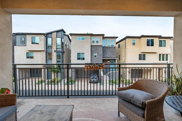 a view of a chair and table in the back yard of the house