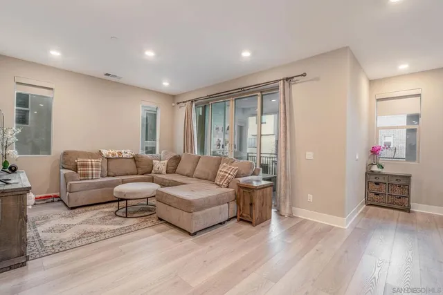 a living room with furniture and a potted plant