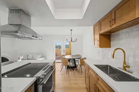 a kitchen with a stove a sink and a refrigerator