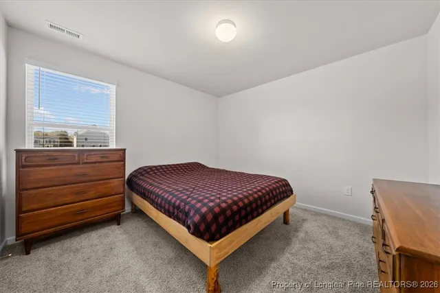 a bedroom with a bed and window
