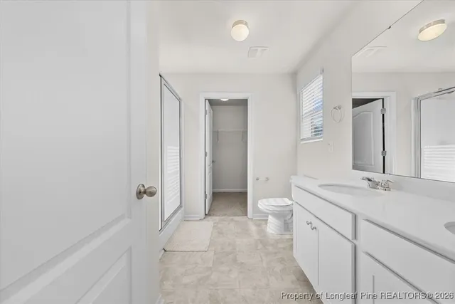 a bathroom with a glass shower door