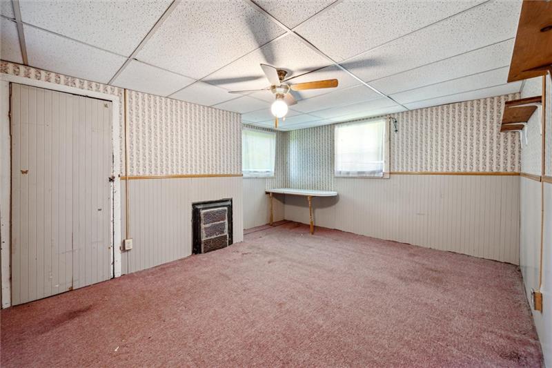 789 Mahoning Road Templeton, PA 16259 - Photo 29 of 41 a view of an empty room with a fireplace and a window