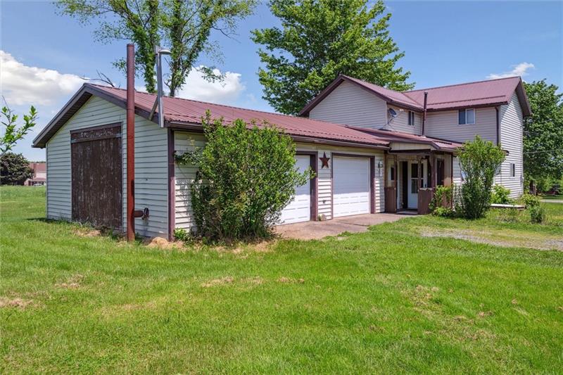 789 Mahoning Road Templeton, PA 16259 - Photo 10 of 41 a view of a house with a yard potted plants and a large tree
