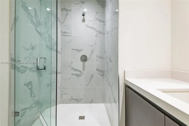 a bathroom with a shower and a sink