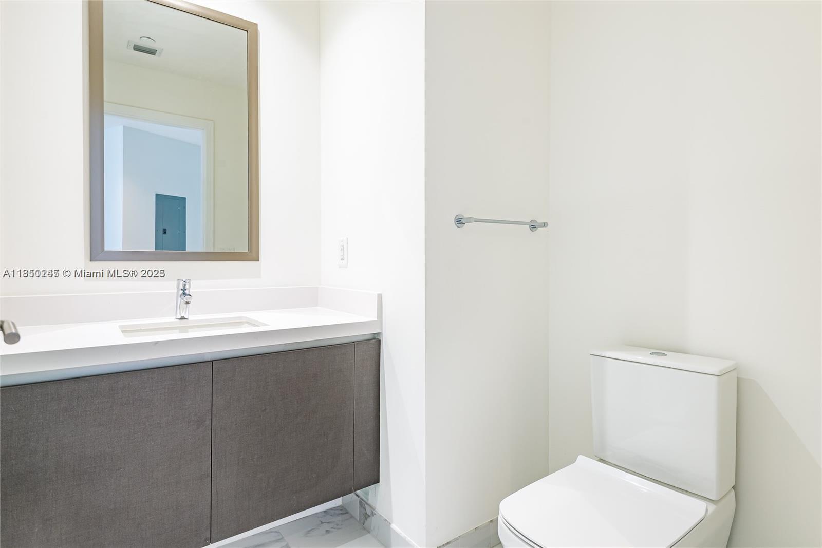 851 Northeast 1st Avenue, Unit 2100 Miami, FL 33132 - Photo 15 of 40 a bathroom with a toilet a sink and mirror