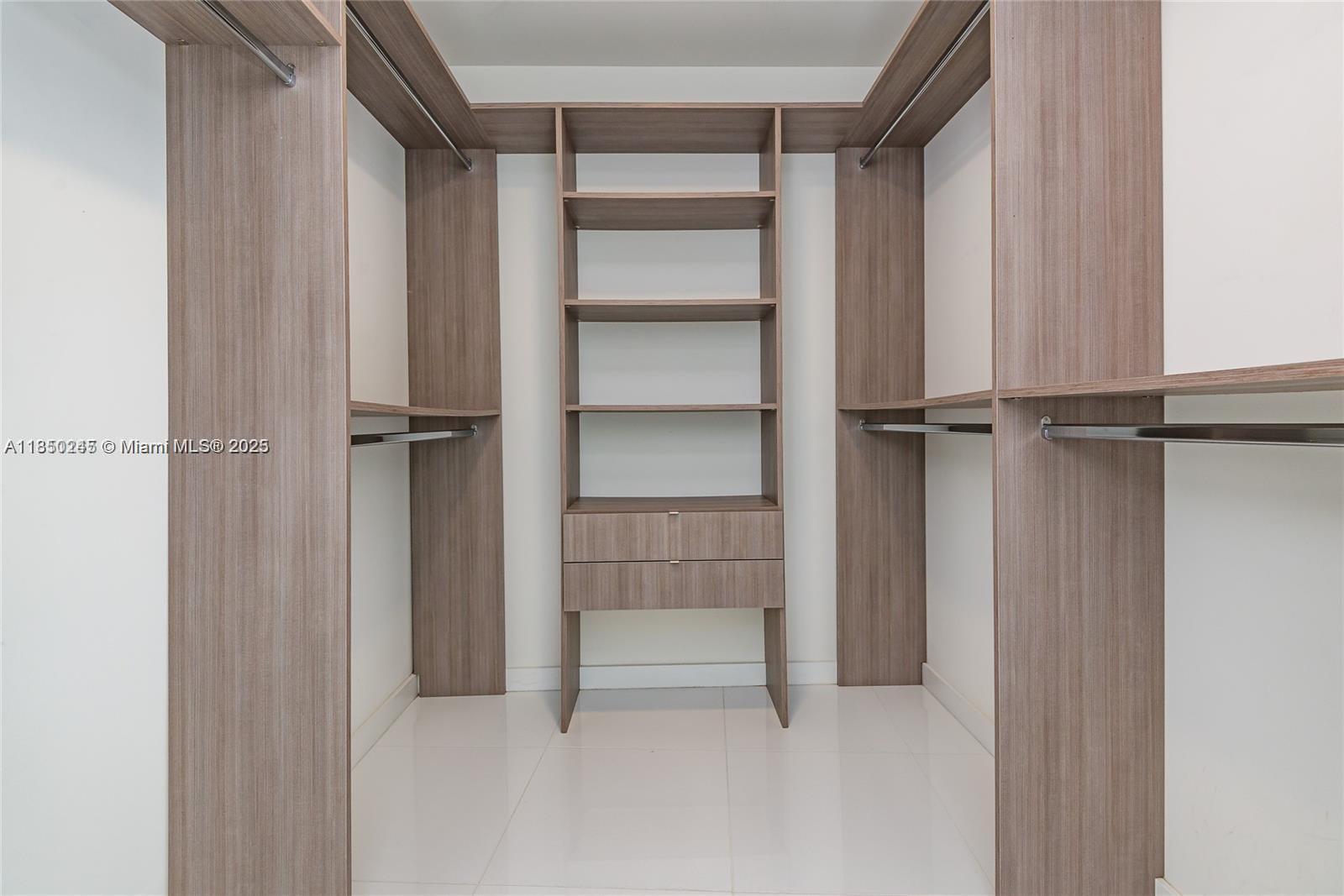 851 Northeast 1st Avenue, Unit 2100 Miami, FL 33132 - Photo 26 of 40 a view of walk in closet with empty racks