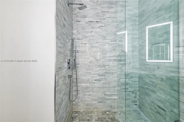 a bathroom with a granite countertop sink a shower and a bathtub