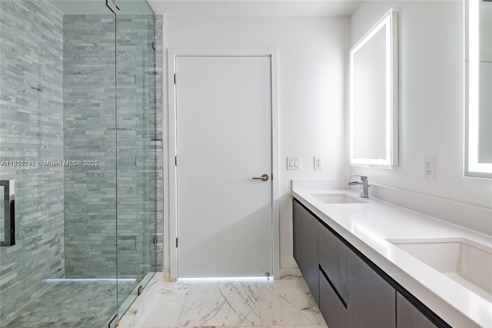 851 Northeast 1st Avenue, Unit 2100 Miami, FL 33132 - Photo 30 of 40 a bathroom with a granite countertop sink a shower and a bathtub