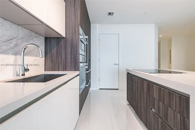 a kitchen with granite countertop a sink and cabinets