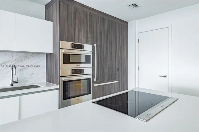 a kitchen with granite countertop a sink and a stove