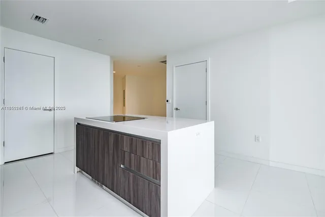 a kitchen with a sink and a refrigerator