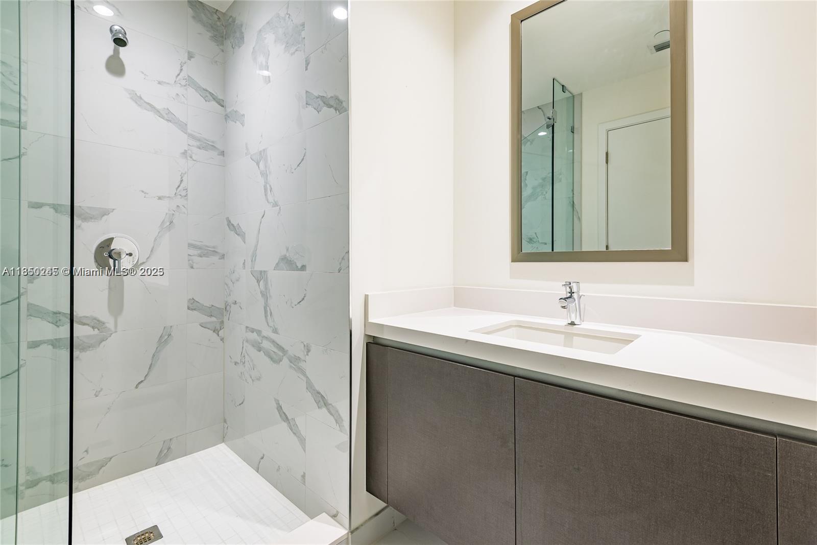 851 Northeast 1st Avenue, Unit 2100 Miami, FL 33132 - Photo 9 of 40 a bathroom with a sink and a mirror